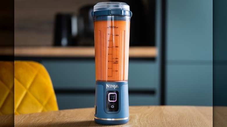A Ninja portable blender sits on a kitchen table