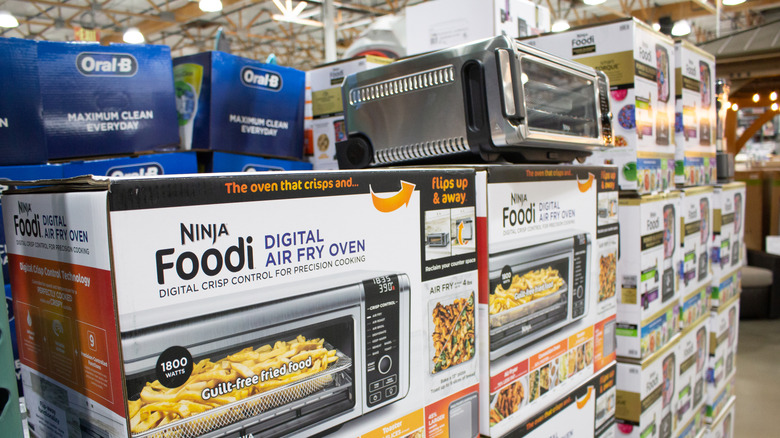 Stacks of boxes of the Ninja Foodi air fryer sit in a retail store