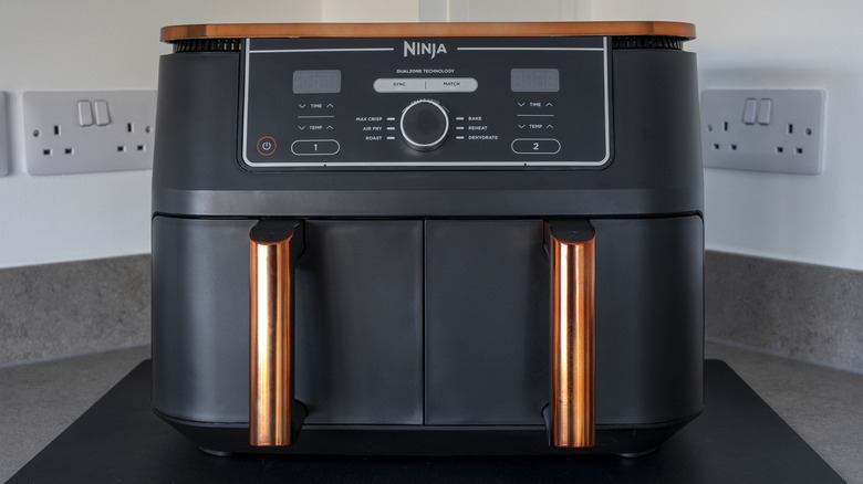 A Ninja double drawer air fryer sits in a kitchen