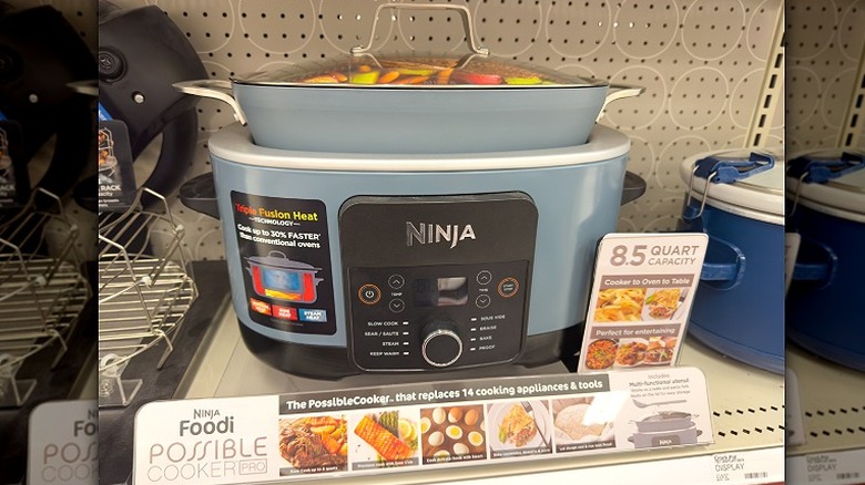 A Ninja Foodi Possible Cooker Pro is displayed on a shelf in a retail store