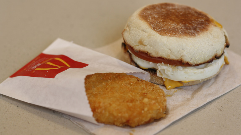 An Egg McMuffin with a hashbrown.
