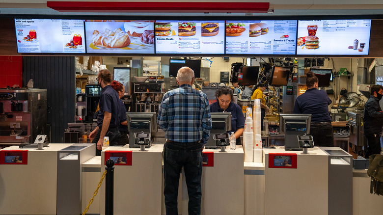 A customer orders at a fast food counter