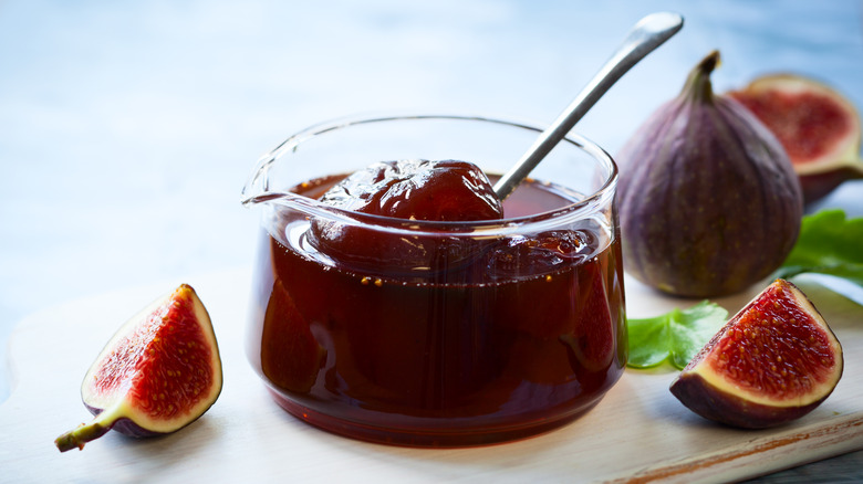 jar of fig jam surrounded by cut figs