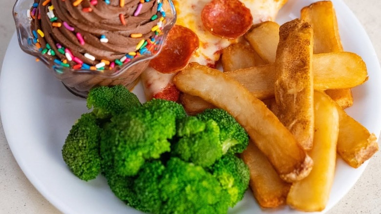Steak fries sit on a plate with broccoli