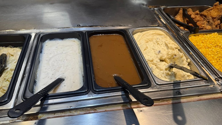 Trays of mashed potatoes and gravy sit in a Golden Corral