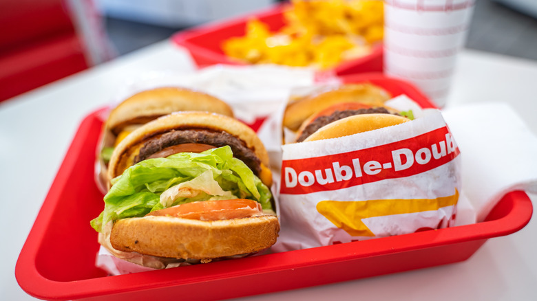 Two In-N-Out Double-Double burgers on a red tray.