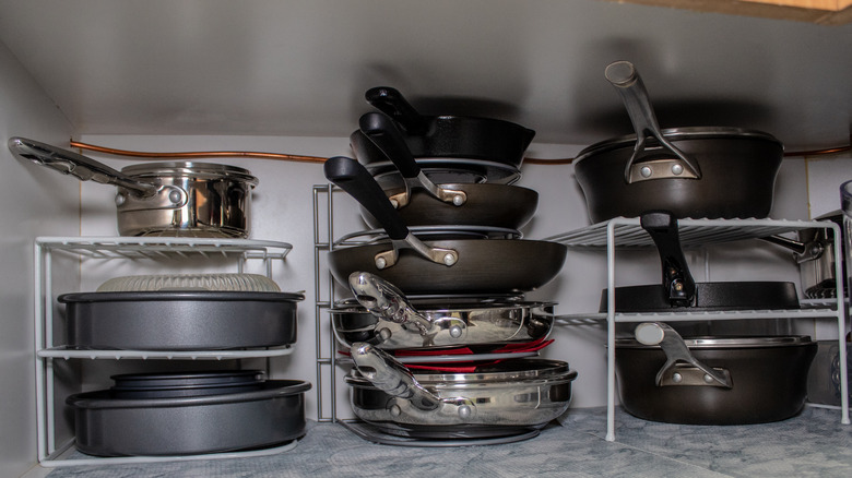 pans stacked in cupboard