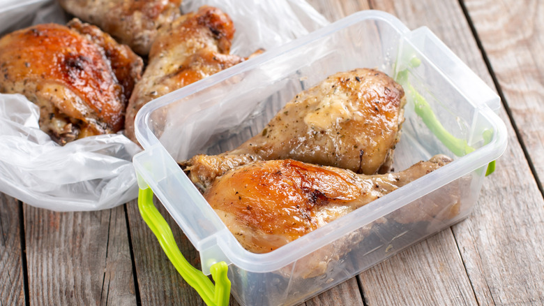 Cooked rotisserie chicken in plastic container and bag ready to be frozen