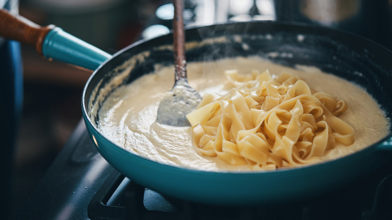 heating pasta alfredo on stove