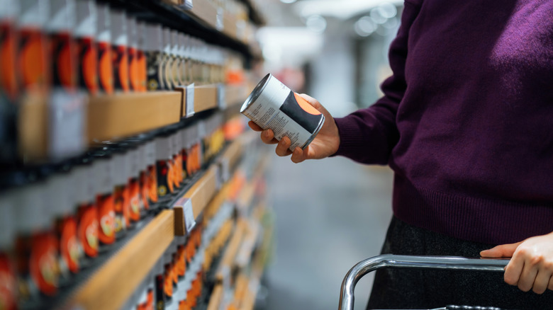 Person shopping for canned produce
