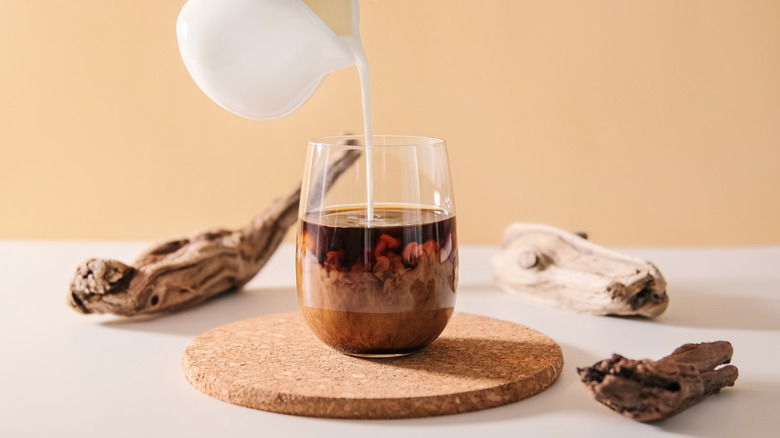 Creamer being poured into coffee