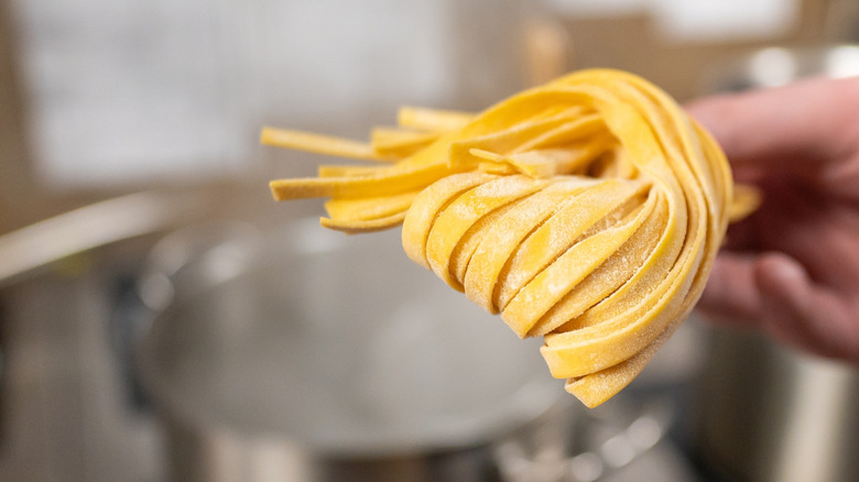 fresh pasta going into a pot