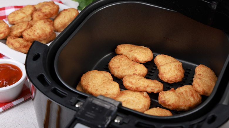 Golden brown chicken nuggets in an air fryer