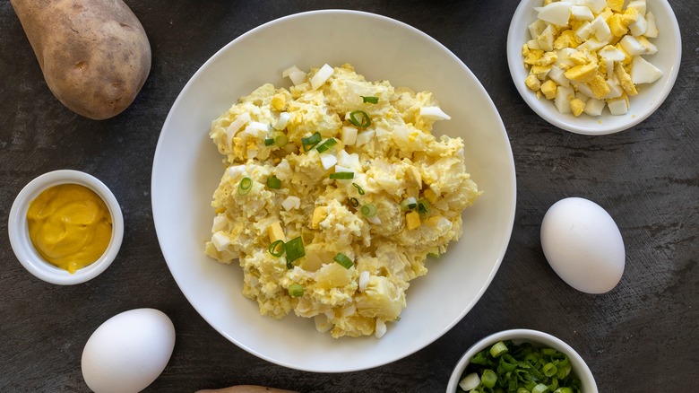 egg salad with potatoes and green onion garnish