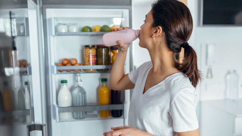 Woman drinking a pink smoothie