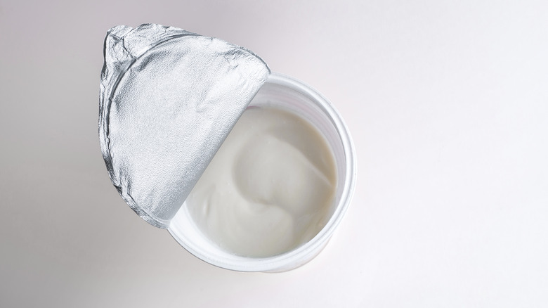 Top view of open container of sour cream