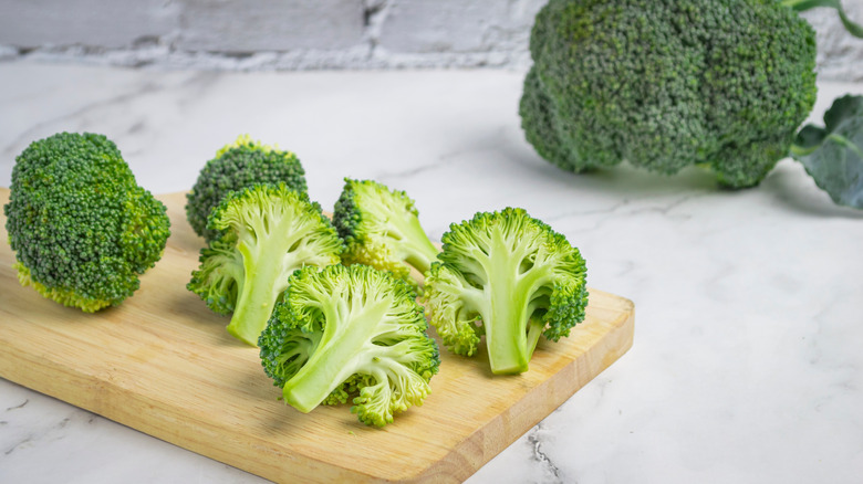 cut broccoli on a cutting board