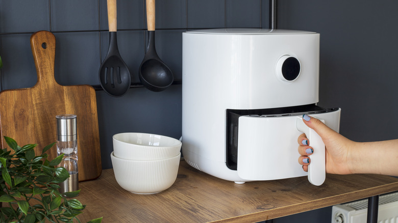 Person removing air fryer basket