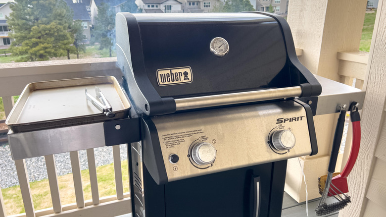 A new Weber grill on a balcony or patio.