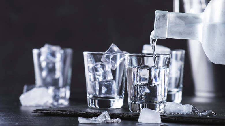 vodka being poured into glasses