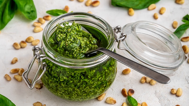 Container of pesto with spoon