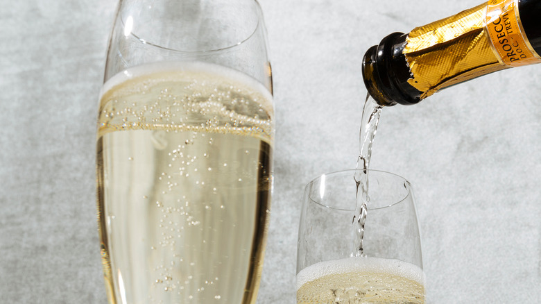 pouring prosecco into a glass