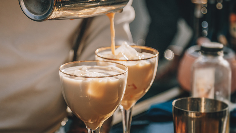 bartender pouring cream liqueur on ice
