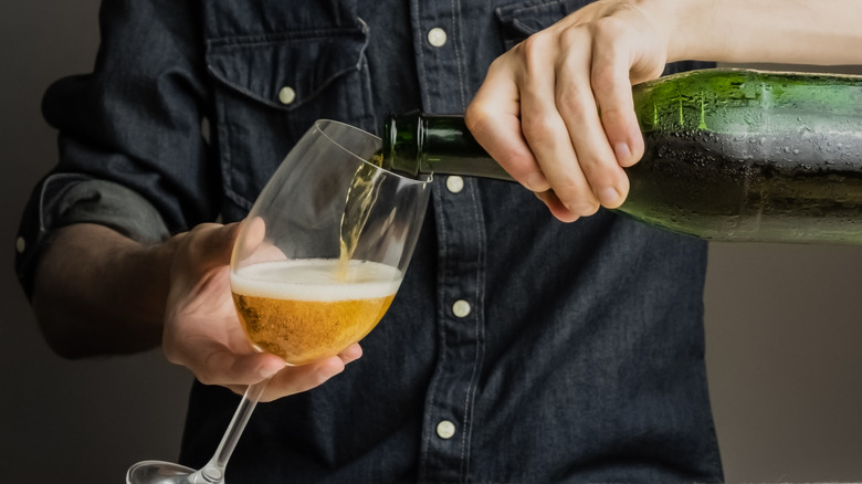 pouring hard cider in a glass