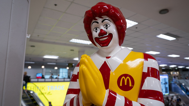 A statue of Ranald McDonald in Thailand shown doing a respectful gesture to welcome customers