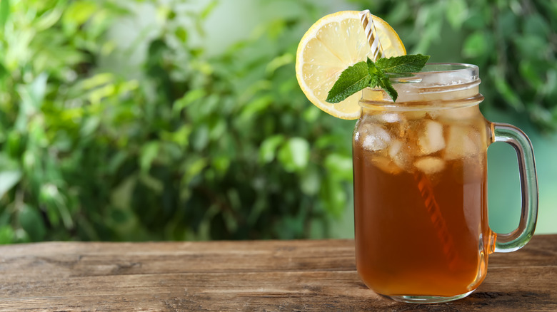 Mason jar of tea against greenery