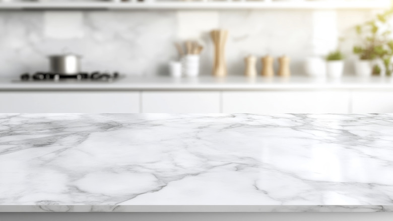 A kitchen with a marble countertop.