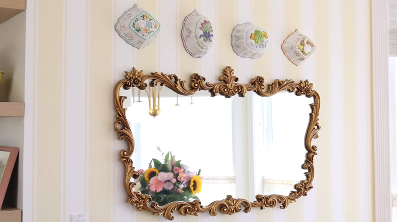 Vintage Jell-O molds used as well decor above a mirror.