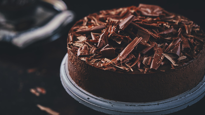 Whole chocolate cake with chocolate shaving garnish