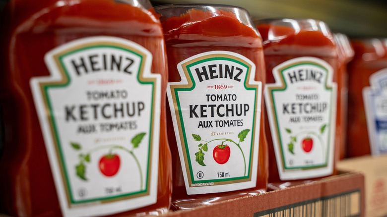 Heinz ketchup bottles on shelves.