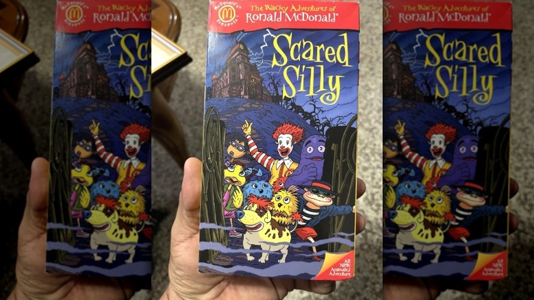 A hand holds a VHS tape of "The Wacky Adventures of Ronald McDonald: Scared Silly" released in 1998.