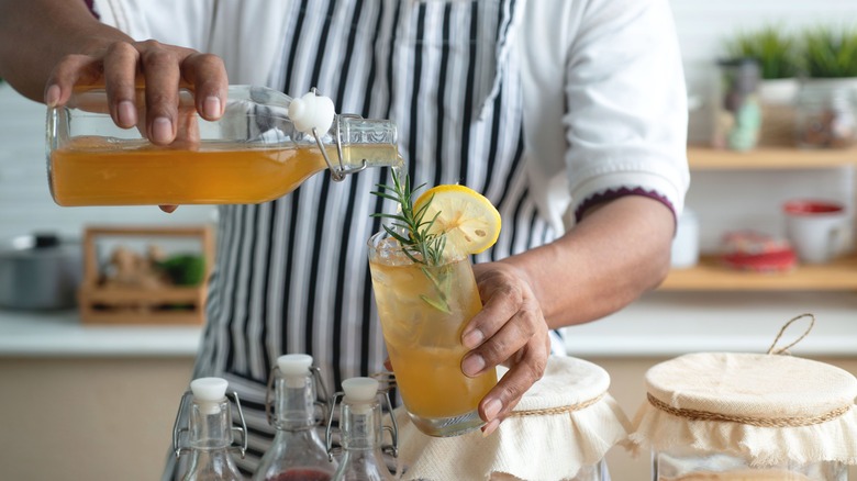 Pouring kombucha into a glass