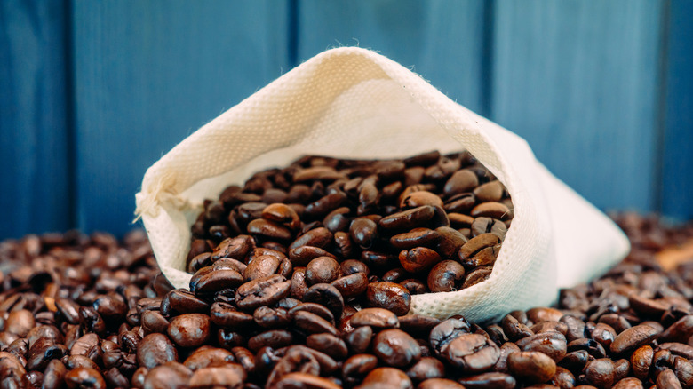 Coffee beans spilling out of a burlap sack