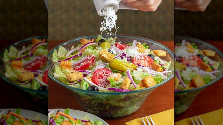 Cheese grated onto an Olive Garden salad.