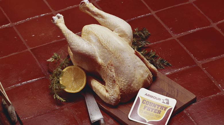 A roasted chicken on a cutting board in the 1970s.