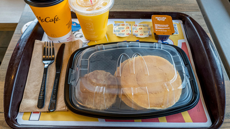 McDonald's breakfast tray featuring hotcakes and beverages.