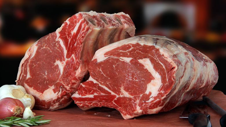 Raw bone-in prime rib roast.