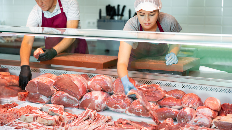 Butchers handling meat.