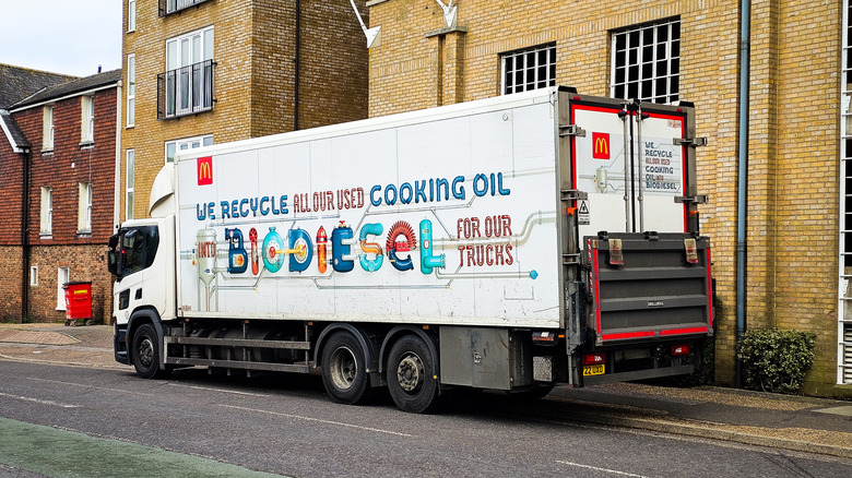 A trucks waits near a building to collect cooking oil