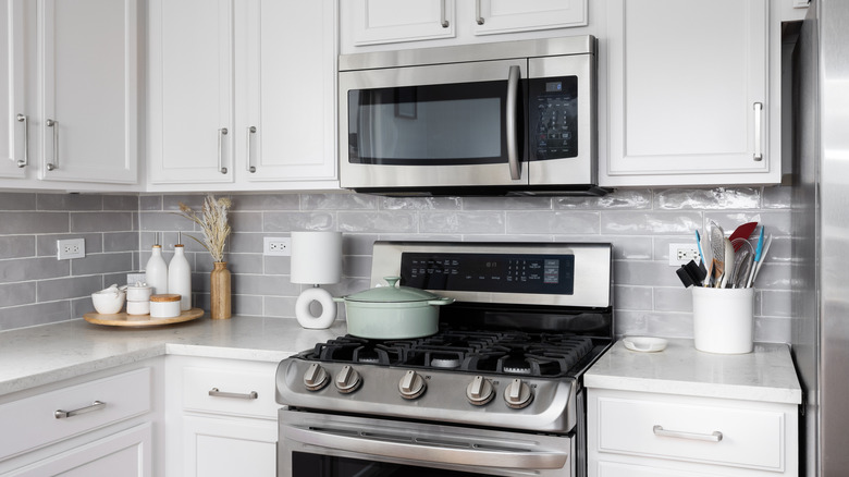 A modern kitchen with a stove-top microwave.