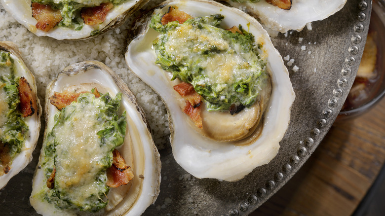 Oysters Rockefeller with green sauce and cheese