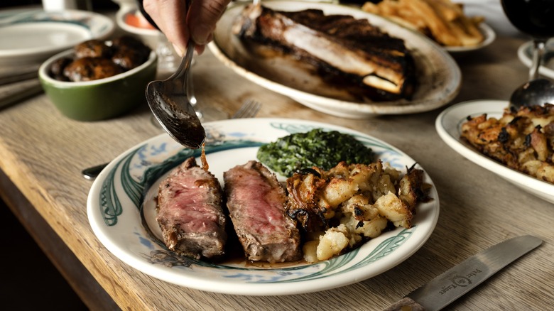 Steak on Peter Luger plate with sides
