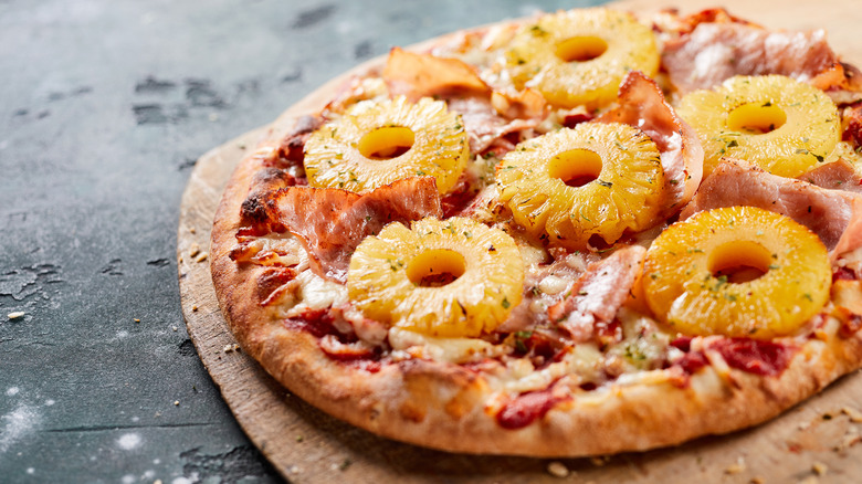 Pizza topped with ringed pineapple