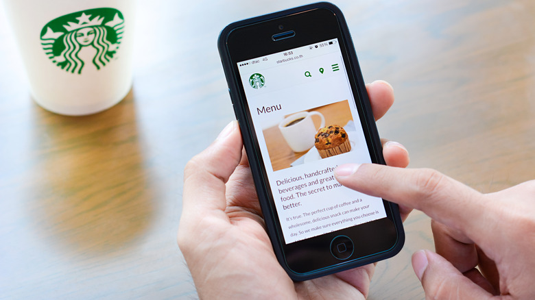 Person looking at Starbucks menu