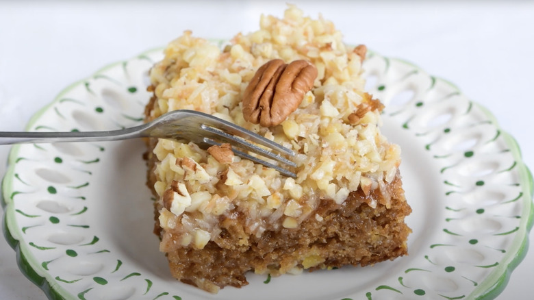 Slice of Texas Tornado Cake topped with a pecan