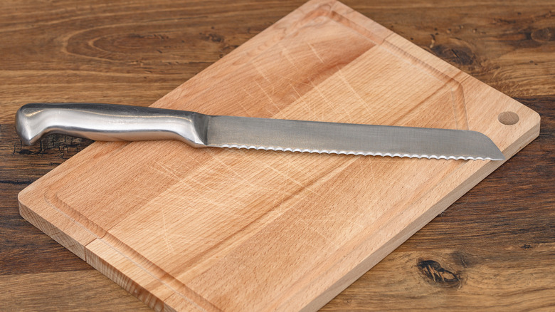 Serrated knife on a cutting board